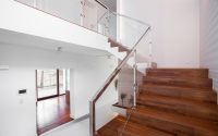 Image of solid wooden stairs with elegant glass balustrade